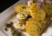 Smoked Yukon Gold Potato Salad with Society Garlic Blossoms, Quail Eggs, and Gribiche Oil
