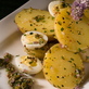 Smoked Yukon Gold Potato Salad with Society Garlic Blossoms, Quail Eggs, and Gribiche Oil